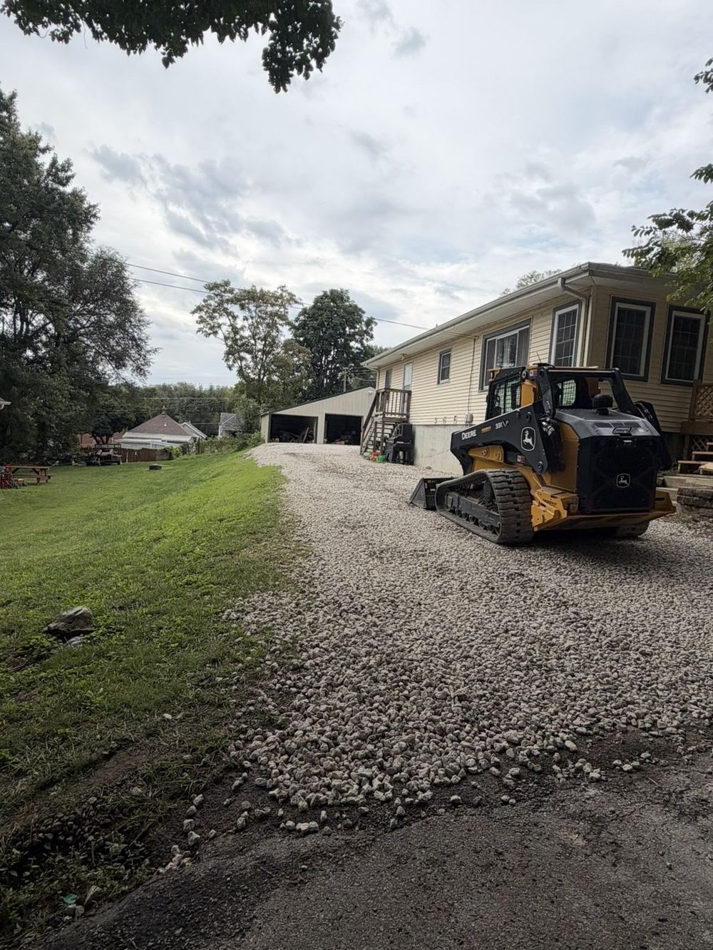 New gravel driveway with a John Deere compact track loader